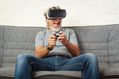Man wearing sunglasses sitting on sofa