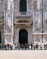 People in front of historical building