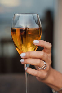 Close-up of hand holding wineglass