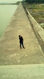 High angle view of girl walking on road