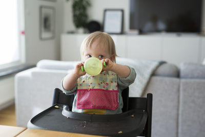 Toddler with down syndrome sitting on high chair