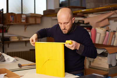 Man reading book at table