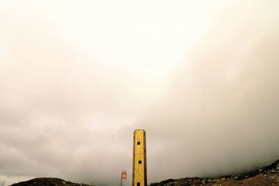 Low angle view of sign against sky during sunset