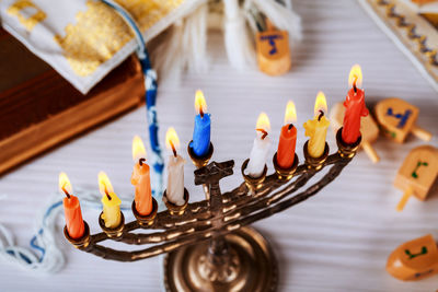 Close-up of colorful candles burning on table