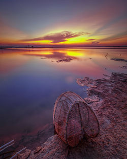 Scenic view of sea against romantic sky at sunset