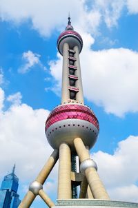 Low angle view of communications tower against sky