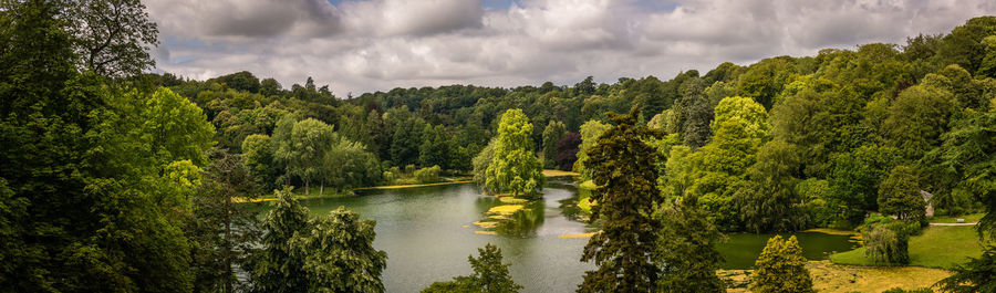 Panoramic view of river amidst trees in forest against sky