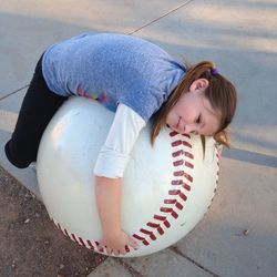 High angle view of girl lying on large ball