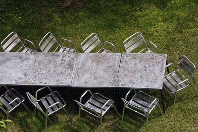 High angle view of empty chairs in yard
