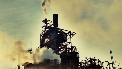 Low angle view of factory against sky