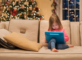 Girl sitting on sofa at home