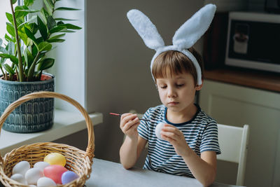 Portrait of cute baby girl holding plant