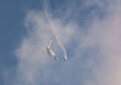 Low angle view of airplane flying in sky