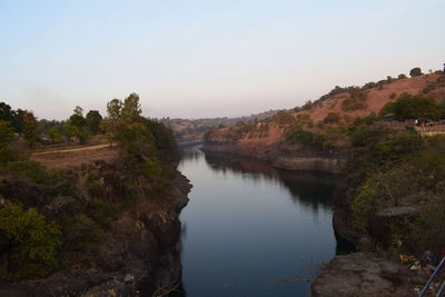 High angle view of river amidst trees against sky