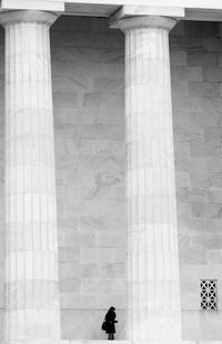 Man standing by large columns at lincoln memorial