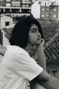 Portrait of young woman looking away outdoors