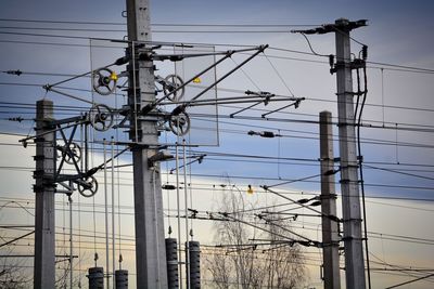 Low angle view of electricity pylon against sky