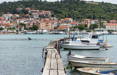 Boats moored at wooden pier in trogir, croatia
