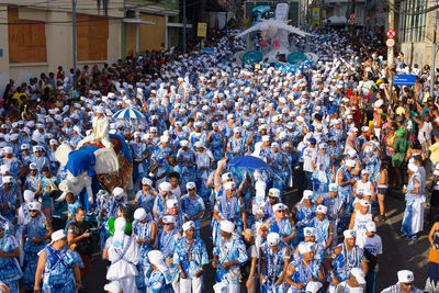 Members of the traditional carnival block filhos de gandy parade in the streets of salvador, 