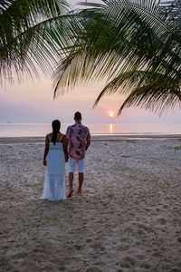 Couple at beach during sunset