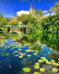 Scenic view of lake by building against sky