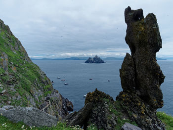 Scenic view of rocks in sea against sky