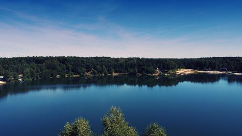 The beautiful blue of the lake and the cloudless sky as seen from the drone