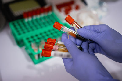 Close-up of hand holding test tube