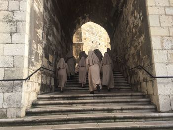 Low angle view of nuns walking up stairs