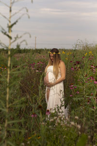 Pregnant woman standing on field