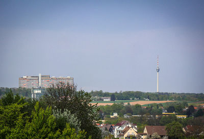 Trees and buildings against sky