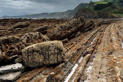 Panoramic view of rocks on land against sky