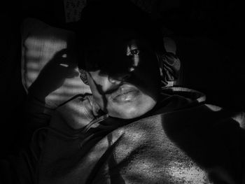 Portrait of man relaxing on bed at home