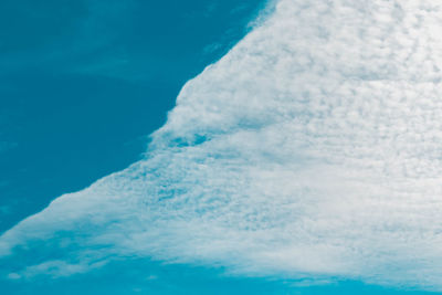 Low angle view of sea against blue sky