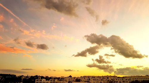 Silhouette landscape against dramatic sky during sunset