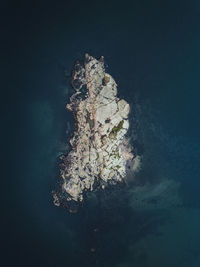 Aerial view of rock formations in sea 