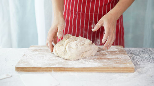 Midsection of person preparing food on table