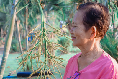 Portrait of woman with pink leaves