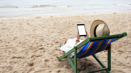 Chair on sand at beach