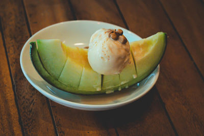 Fruity melon dessert, topped with vanilla ice cream