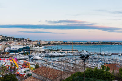 High angle view of townscape by sea against sky