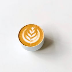 Close-up of coffee cup over white background