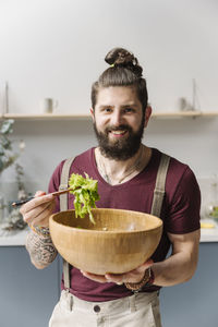 Portrait of young man holding ice cream