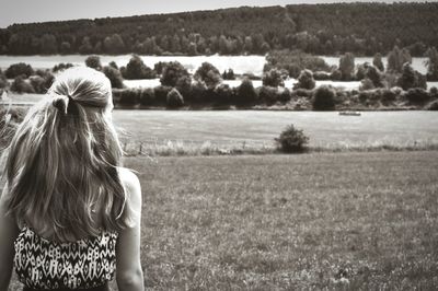 Woman standing on grassy field