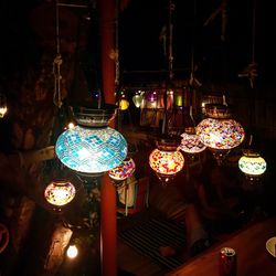 Close-up of illuminated chandelier hanging at night