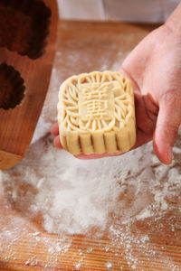 High angle view of man preparing cake on cutting board