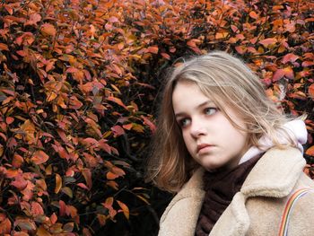 Portrait of woman in autumn leaves