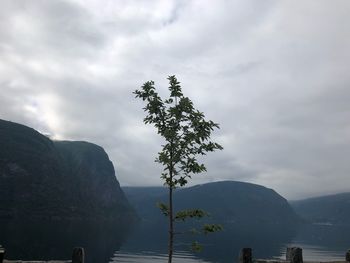 Scenic view of lake by mountains against sky