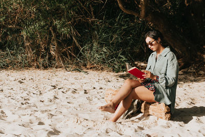 Young woman sitting on field