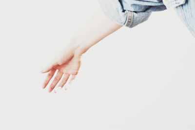 Woman holding hands over white background